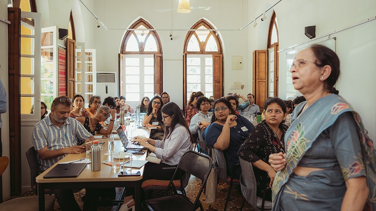 Participants seated around tables at the 10K2Zero Brainstorming Lab